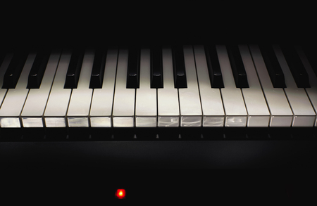 Black and white piano keys in dark ambiance. Part of modern midi controller.の写真素材