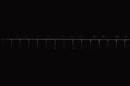 Black and white piano keys in dark ambiance. Accentuated highlights. 