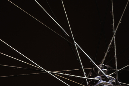 Closeup details of modern bicycle, accentuated shapes with light.の写真素材