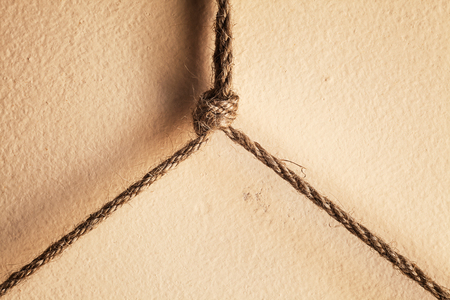 Abstract composition of small ropes and knot over the wall.の写真素材