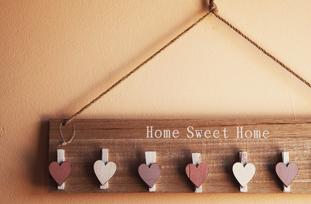 Interesting hanger with clothespins decorated with wooden hearts.の写真素材