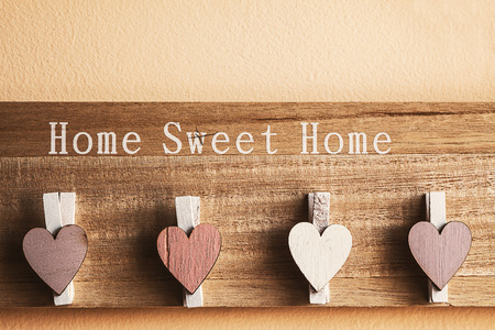 Interesting hanger with clothespins decorated with wooden hearts.の写真素材