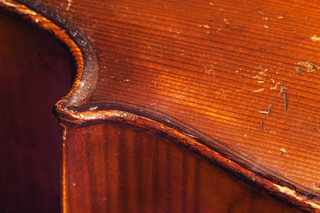 Details of an old dusty cello, closeup view on body wood parts.の写真素材