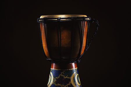 Closeup view of an old wooden djembe, details of ropes, skin and wood.の写真素材