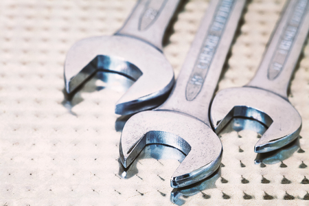 Abstract composition of metal wrench and surface.の写真素材