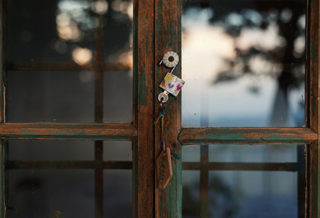 Closeup view of an old vintage style wooden window, exterior details of an old wooden cottage.の写真素材