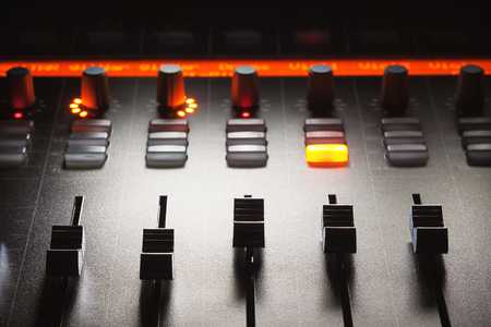 Faders of a modern mixing console, music studio equipment details.の写真素材