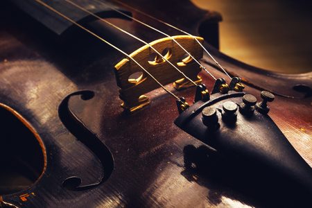 Closeup view on old dusty violin, details of wood and structure.の写真素材