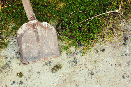 Old and dirty shovel on asphalt, scene from a village life.の写真素材