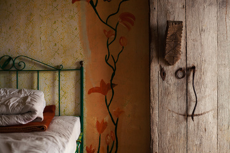One part of an old retro style wooden house, interior details of furniture, wall decorations and entrance door.の写真素材