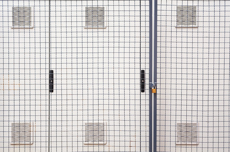 Safety locked electricity closet, outdoor abstract composition.の写真素材