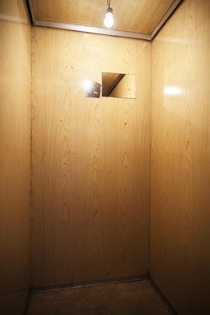 Wooden walls of an old and small elevator, interior details.の写真素材