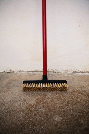 Domestic plastic broom on floor, abstract simple composition.の写真素材
