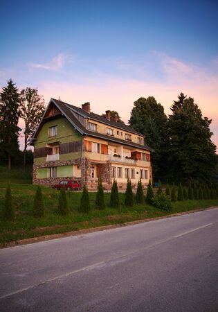 Big and old village house at sunset.の写真素材