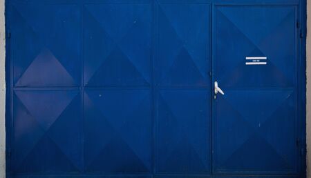 Entrance of a garage, details of blue metal doors.の写真素材
