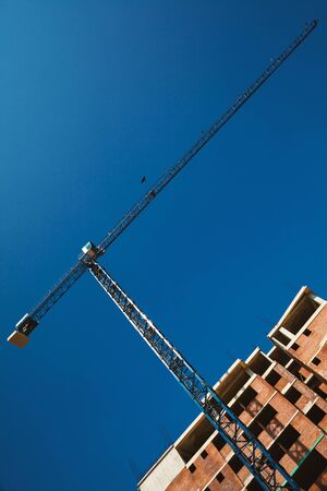 Abstract composition of building buildings, big crane and construction.の写真素材