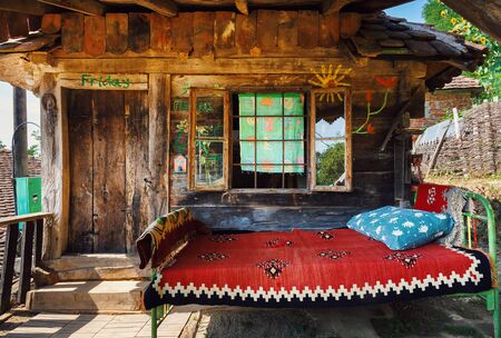 Old wooden house exterior. Part of a traditional household from Serbia, during summer.の写真素材