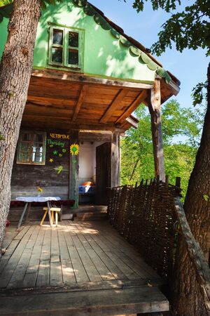 Old wooden house exterior. Part of a traditional household from Serbia, during summer.の写真素材