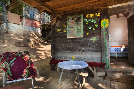 Old wooden house exterior. Part of a traditional household from Serbia, during summer.の写真素材