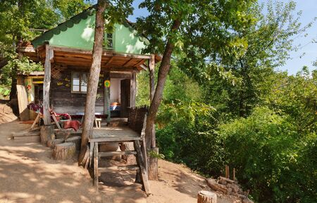 Old wooden house exterior. Part of a traditional household from Serbia, during summer.の写真素材