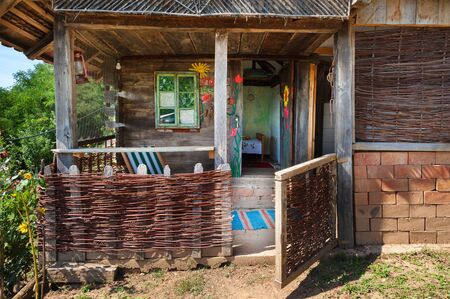 Old wooden house exterior. Part of a traditional household from Serbia, during summer.の写真素材