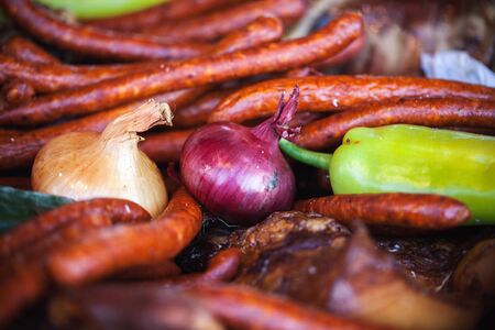 A lot of sausages and colorful vegetables.の写真素材