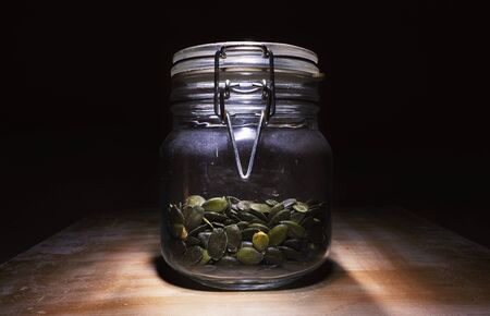 Dry sunflower seeds in a glass bottle.の写真素材