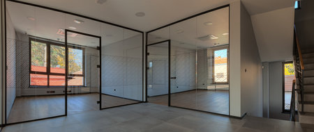 New and empty office interior, entrance wall of glass, during day.の写真素材