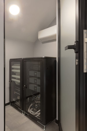 Modern rack of equipment for internet and multimedia devices installed in building.