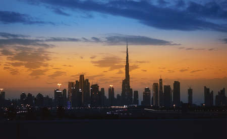 Dubai, United Arab Emirates - January 18, 2022: Dubai city and Burj Khalifa by night, viewed from car on high way.のeditorial素材