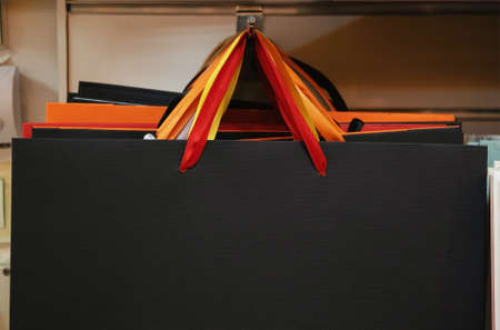 Front view of decorative paper bags hanged in shop.の写真素材