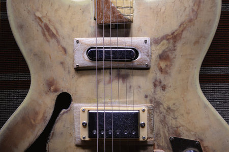 Details of an old vintage style electric guitar, archtop model with f holes.