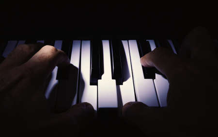 Simple composition, two hands playing a synth.の写真素材