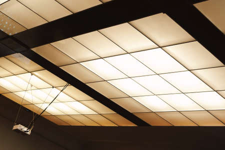 Modern ceiling lighting of the conference hall with a video projector in one part.の写真素材