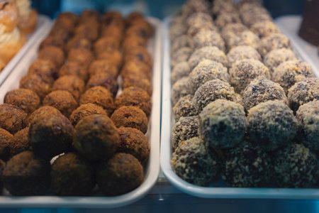 Cakes in a display case, various types, close-up view.