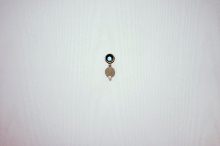 Door spy on white wooden door, open, cover down.の写真素材