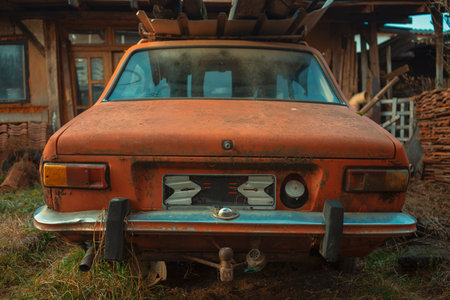 The back of an old broken car, parked in the yard.の写真素材