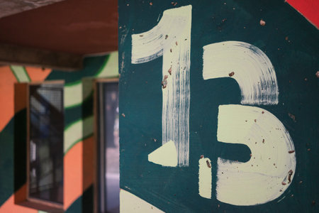 Painted walls at the entrance to the building with the number thirteen.の写真素材