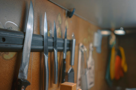 A close-up view of the kitchen knives attached to the magnetic plate.の写真素材