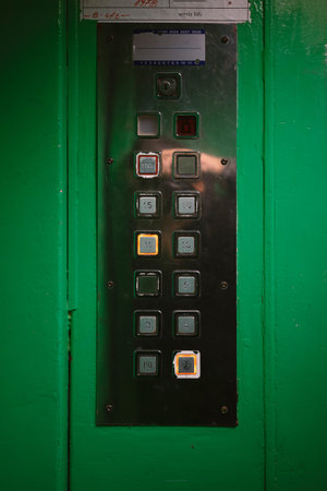 Metal elevator control panel with floor selection buttons, the eleventh floor is selected. The...