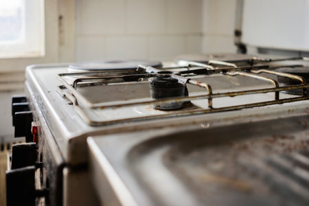 Parts of a gas stove, old dirty parts full of hair and dirt, close up view.の写真素材