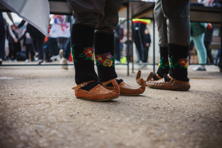 Traditional Serbian costume, opanka and socks close up, group of people with Serbian flag in the background.の写真素材