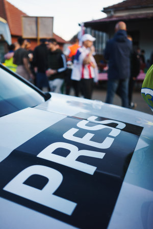 Journalists at work, focus on the newspaper sign on the car.の写真素材