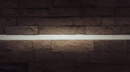 Interesting facade decorative bricks under dramatic lighting.