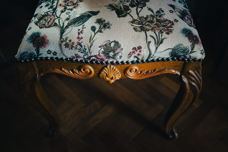 Details of a beautiful decorative chair, the parquet can be seen in the background.