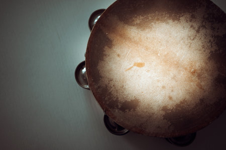 Old wooden tambourines with leather on a white surface.の写真素材