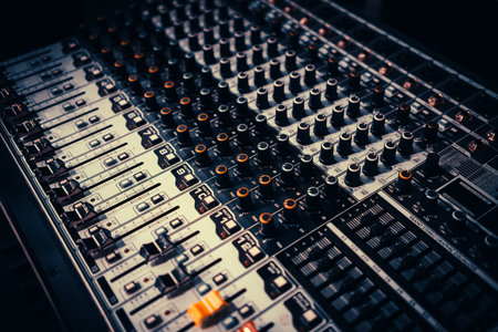 Modern audio mixer control panel with faders and buttons.