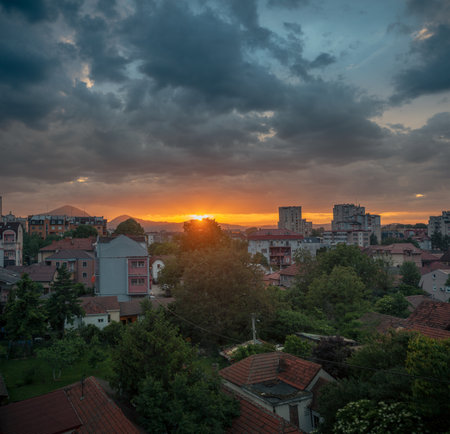 Balkan city landscape at sunset with dramatic sky, spring time. Cacak in Serbia.の写真素材