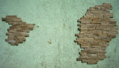 Decorative facade brick on a light green wall, abstract construction.の写真素材
