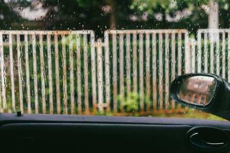 View from the car while it's raining, details of the interior and windows.